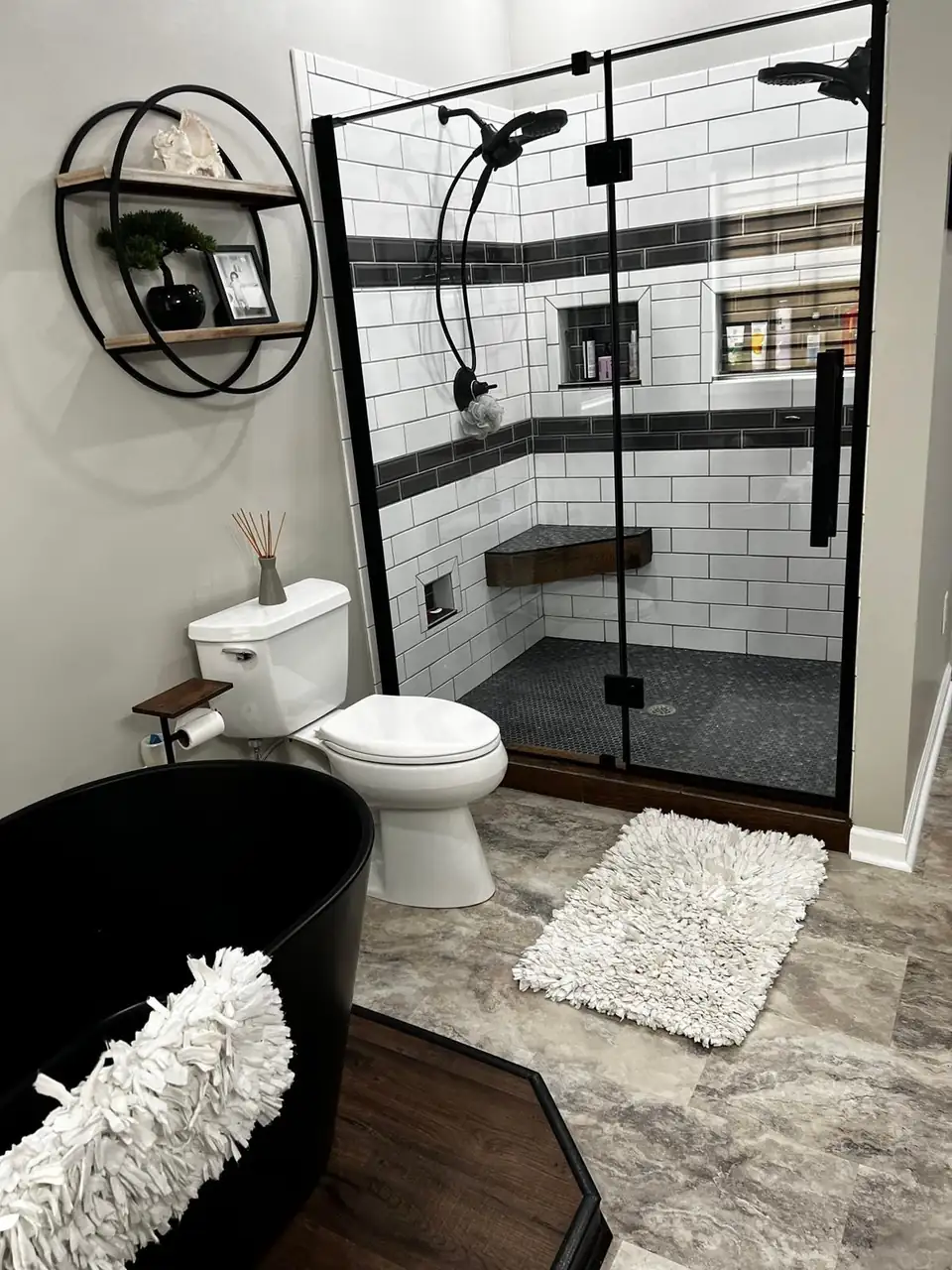 Bathroom remodeling in Paducah: walk-in shower with white subway tile, black accent band, black-framed glass and a freestanding black tub