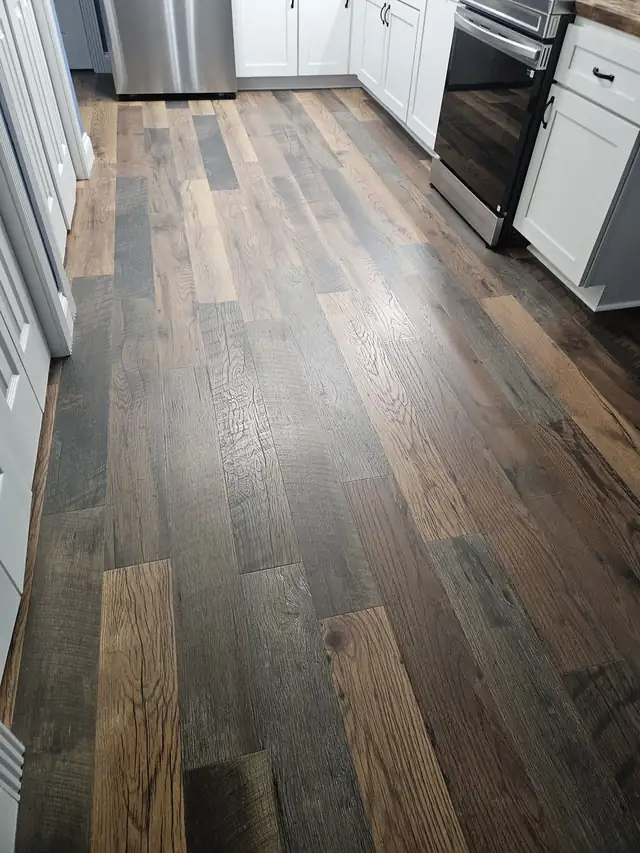 Rustic multi-tone wood-look plank flooring installed in a hallway